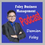 Foley Business Management Podcast with Damien Foley picture of Damien Foley wearing charcoal grey suit, royal blue collared shirt and glasses all on a purple background